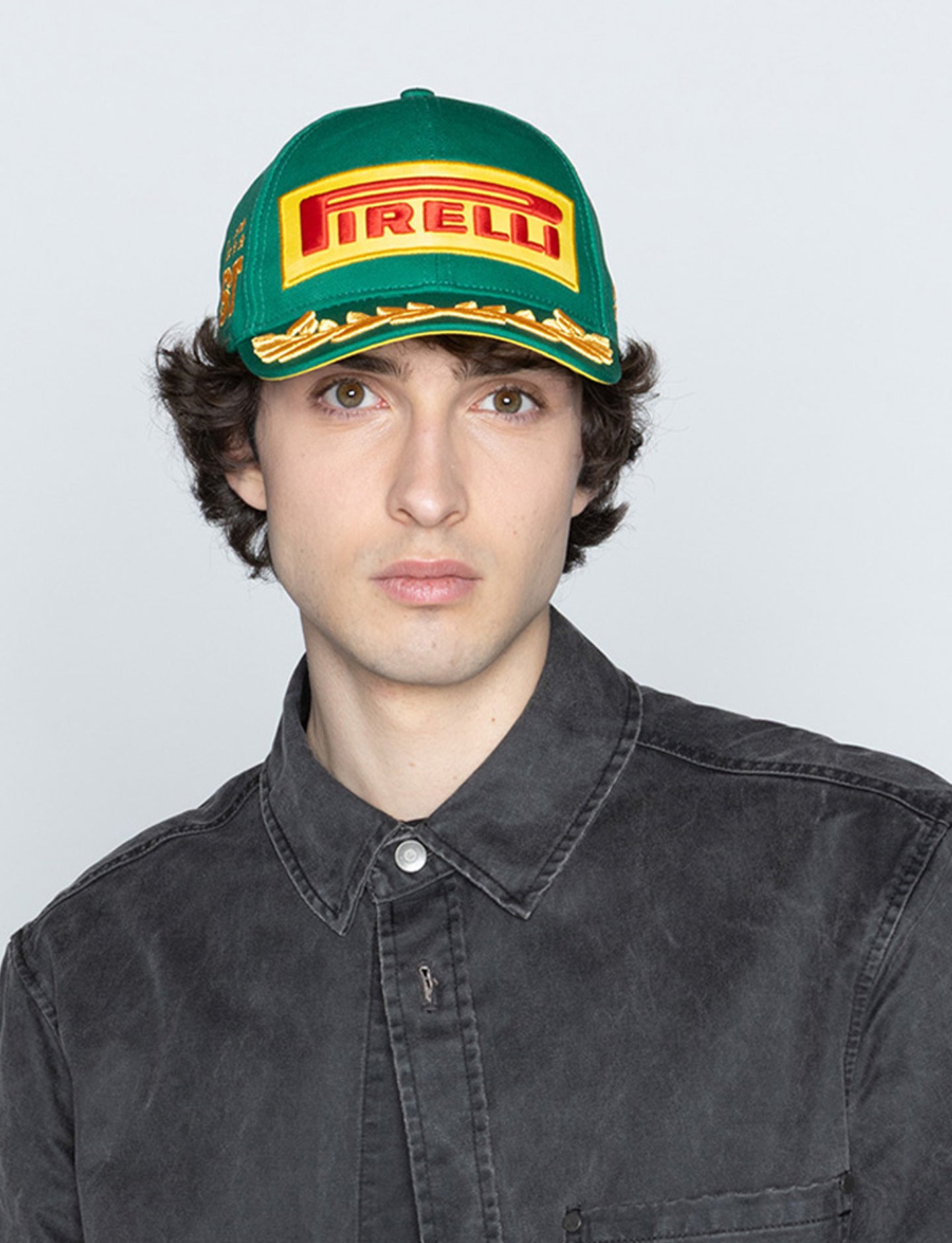 man with Pirelli cap green front view
