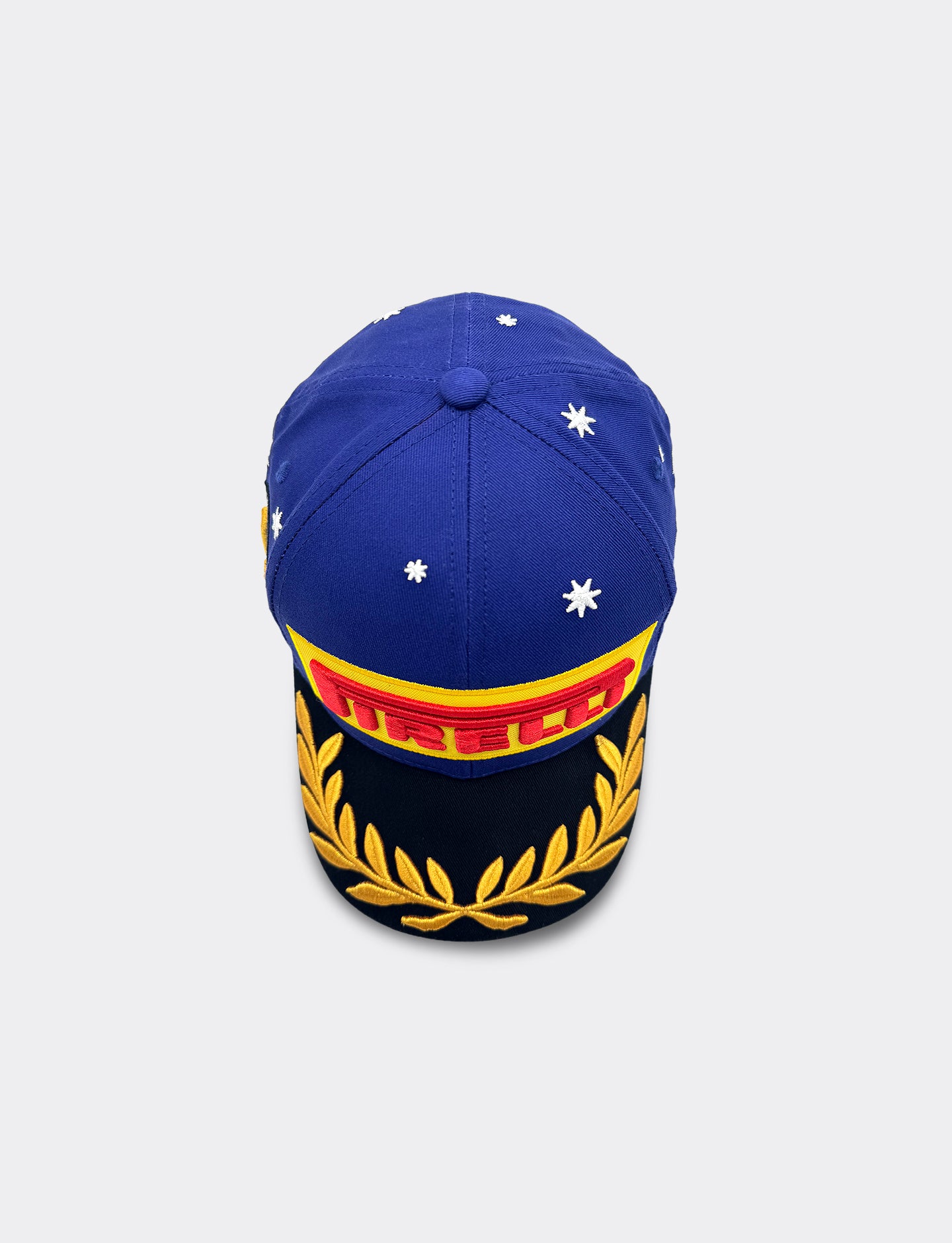 Blue Pirelli Podium Cap with red and yellow Pirelli logo on a light gray background from above view