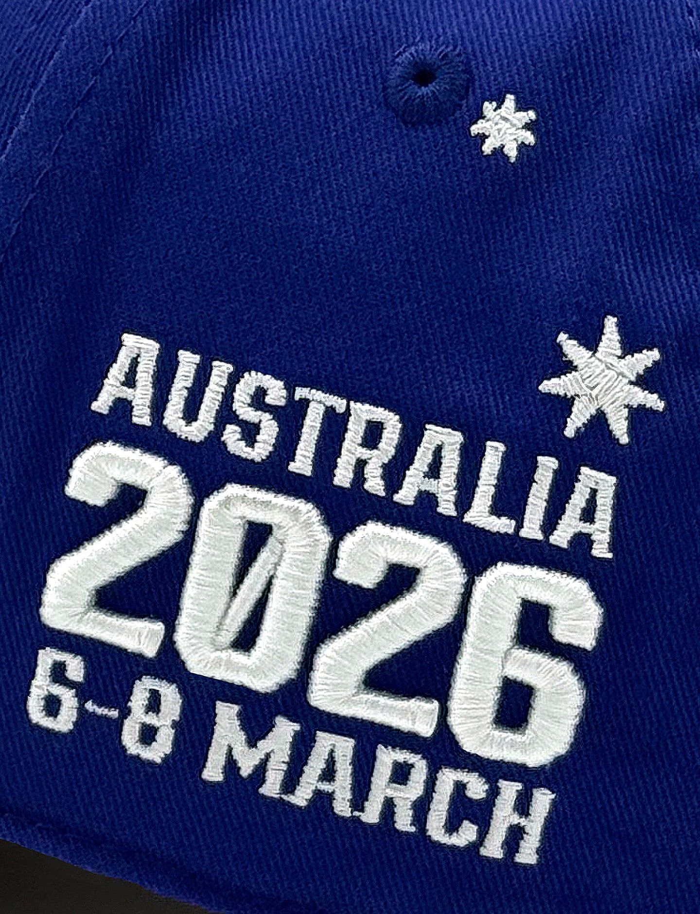 close up embroidery on cap "Australia 2026 6-8 March"