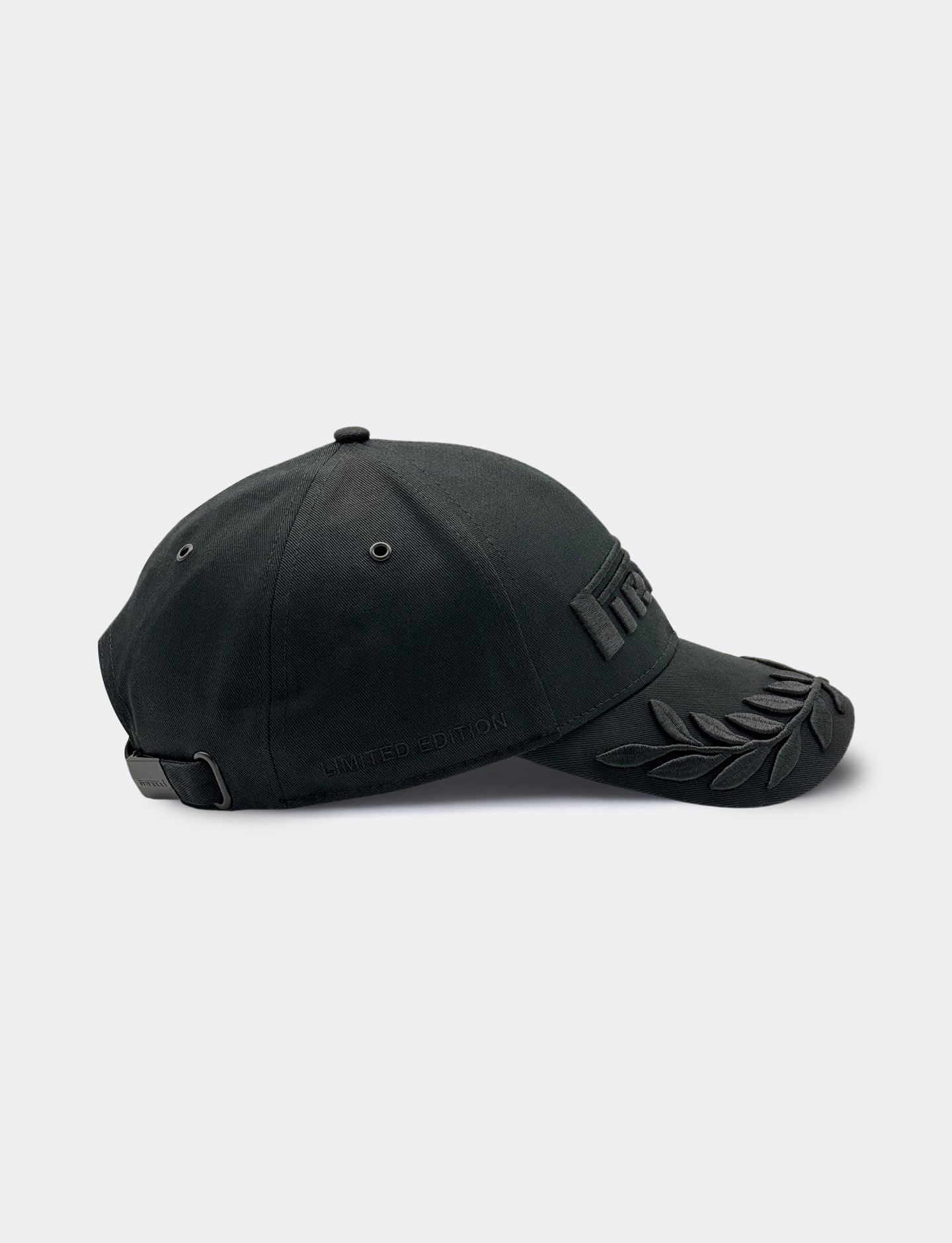 Black cap with a Pirelli logo on a light gray background