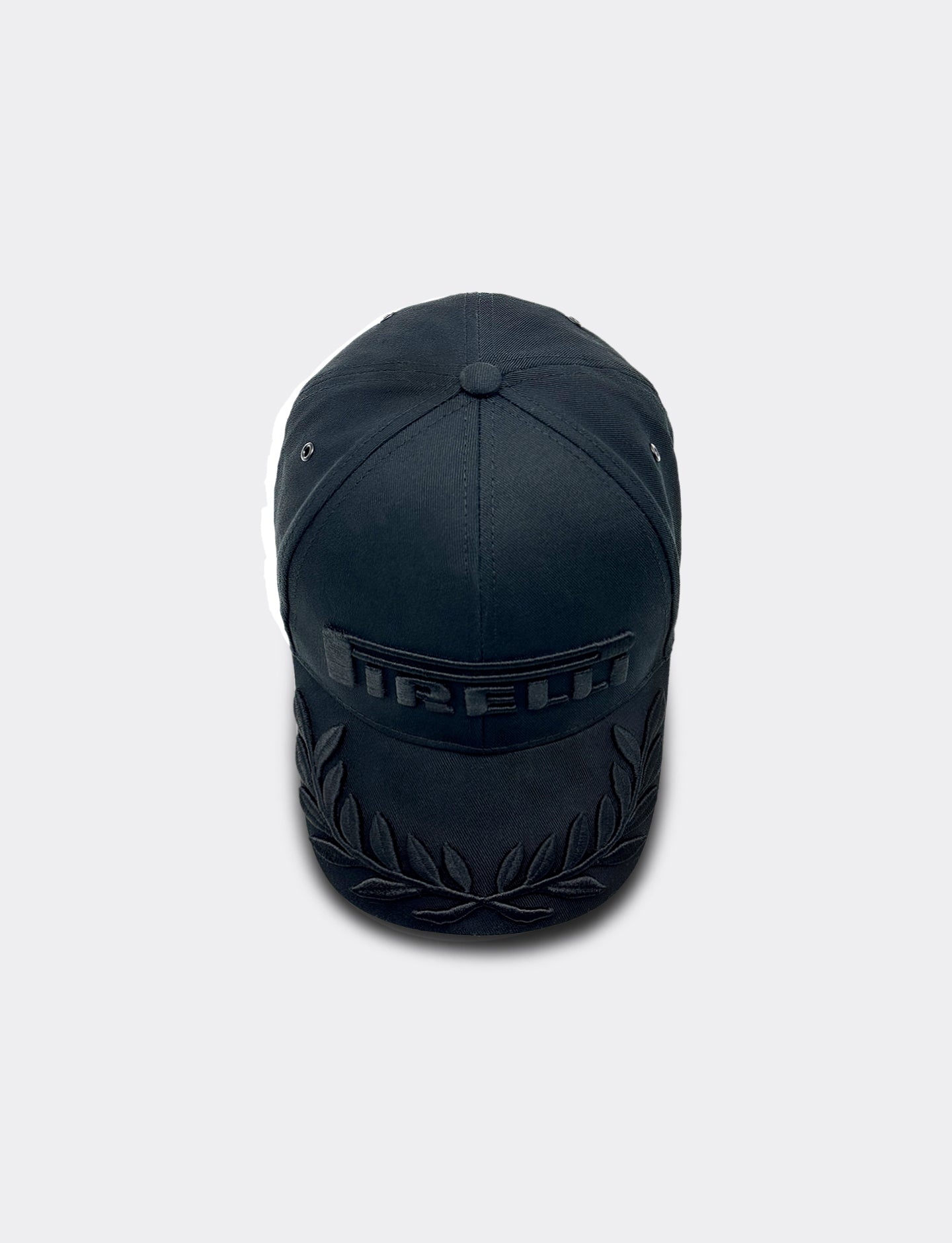 Black cap with Pirelli branding on a light gray background