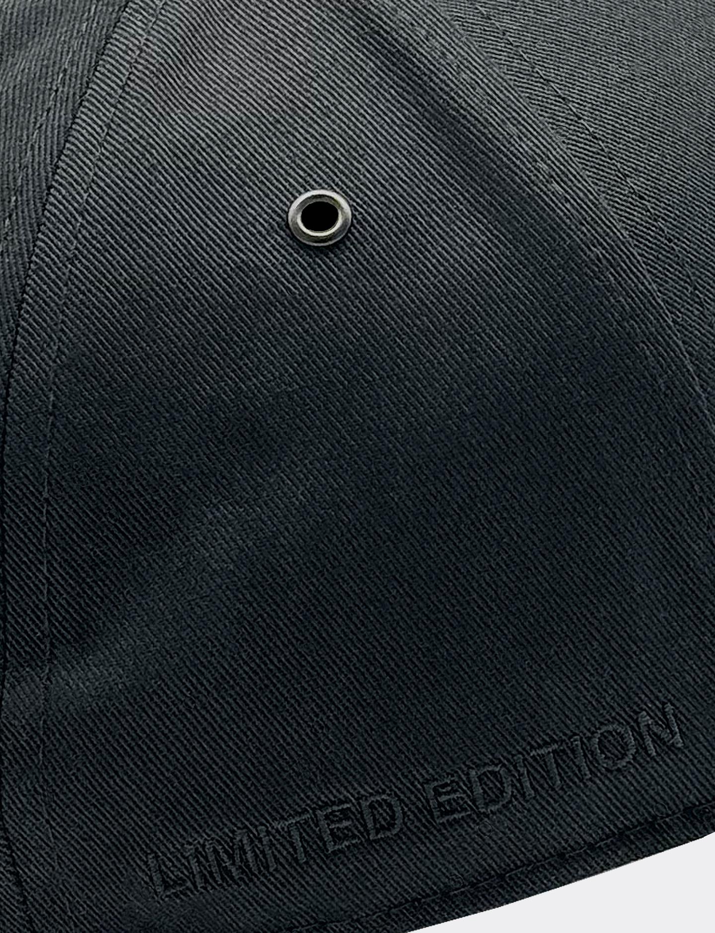 Black cap with 'Limited Edition' text and a metal eyelet on a white background