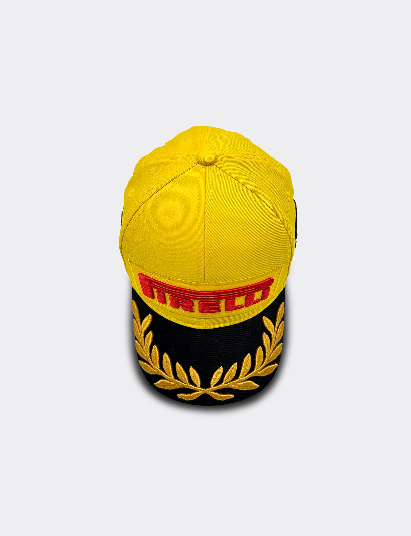 Yellow Pirelli cap with red logo on a white background
