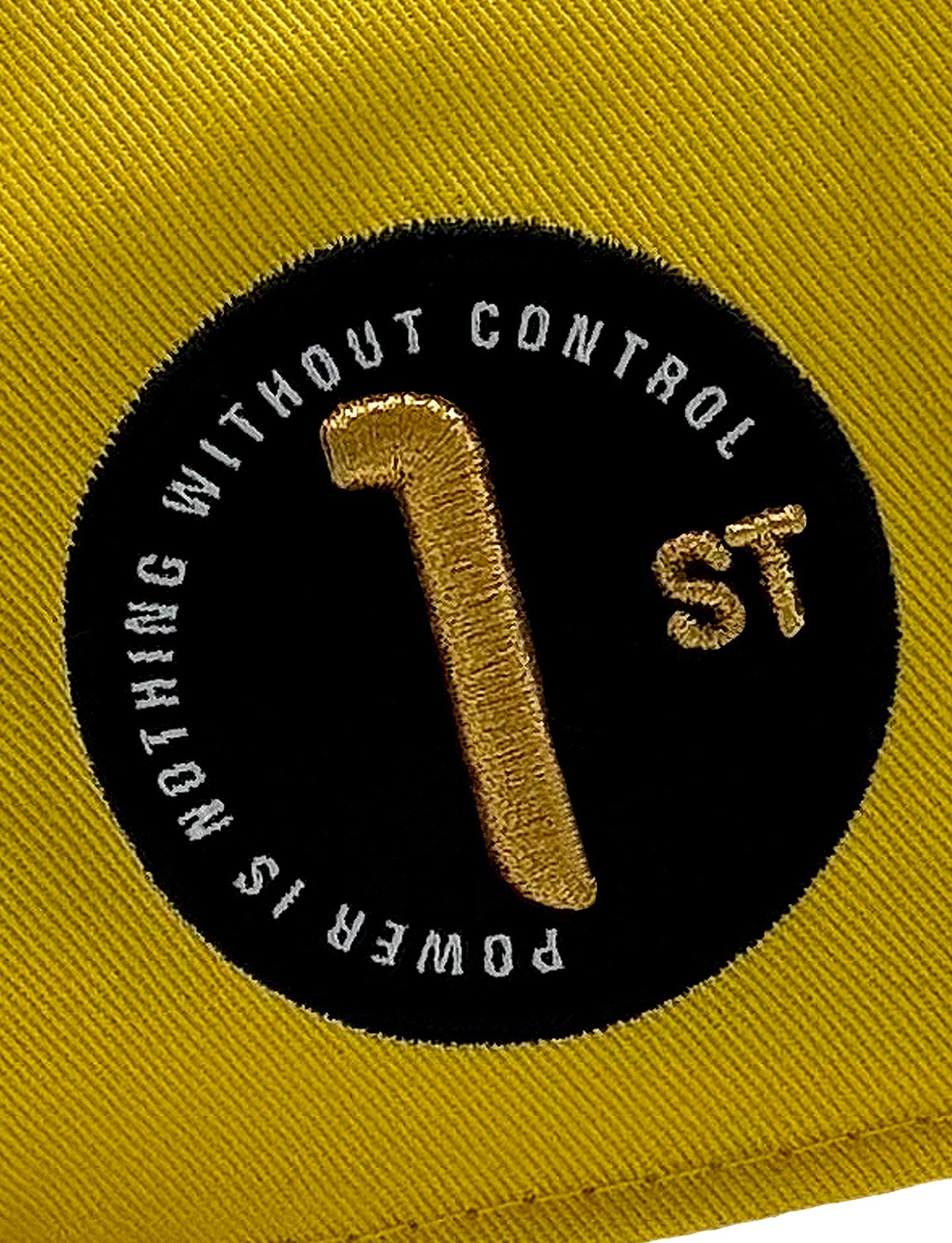 Yellow cap with black circular logo featuring text and number '1'.