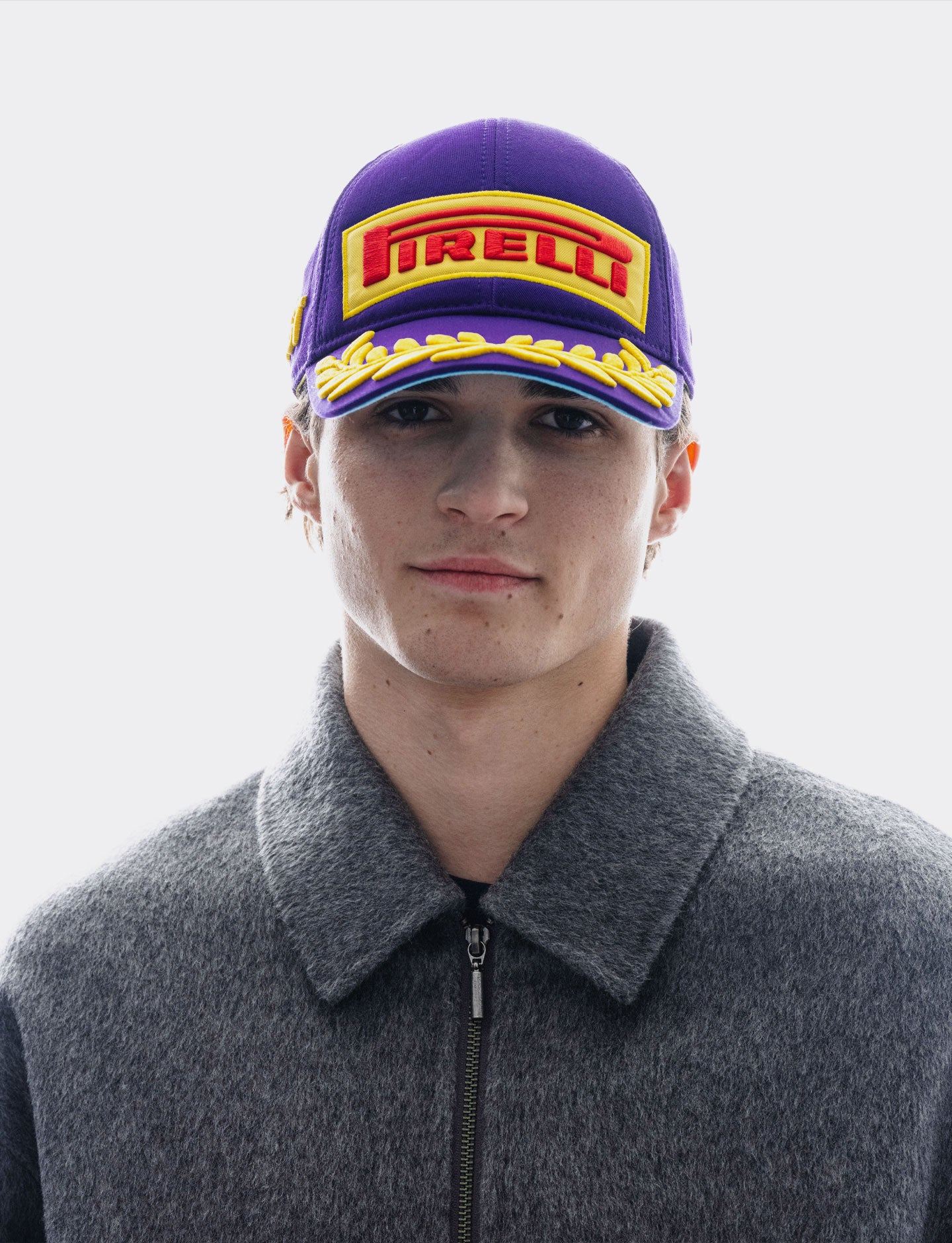 man wearing a purple Pirelli cap