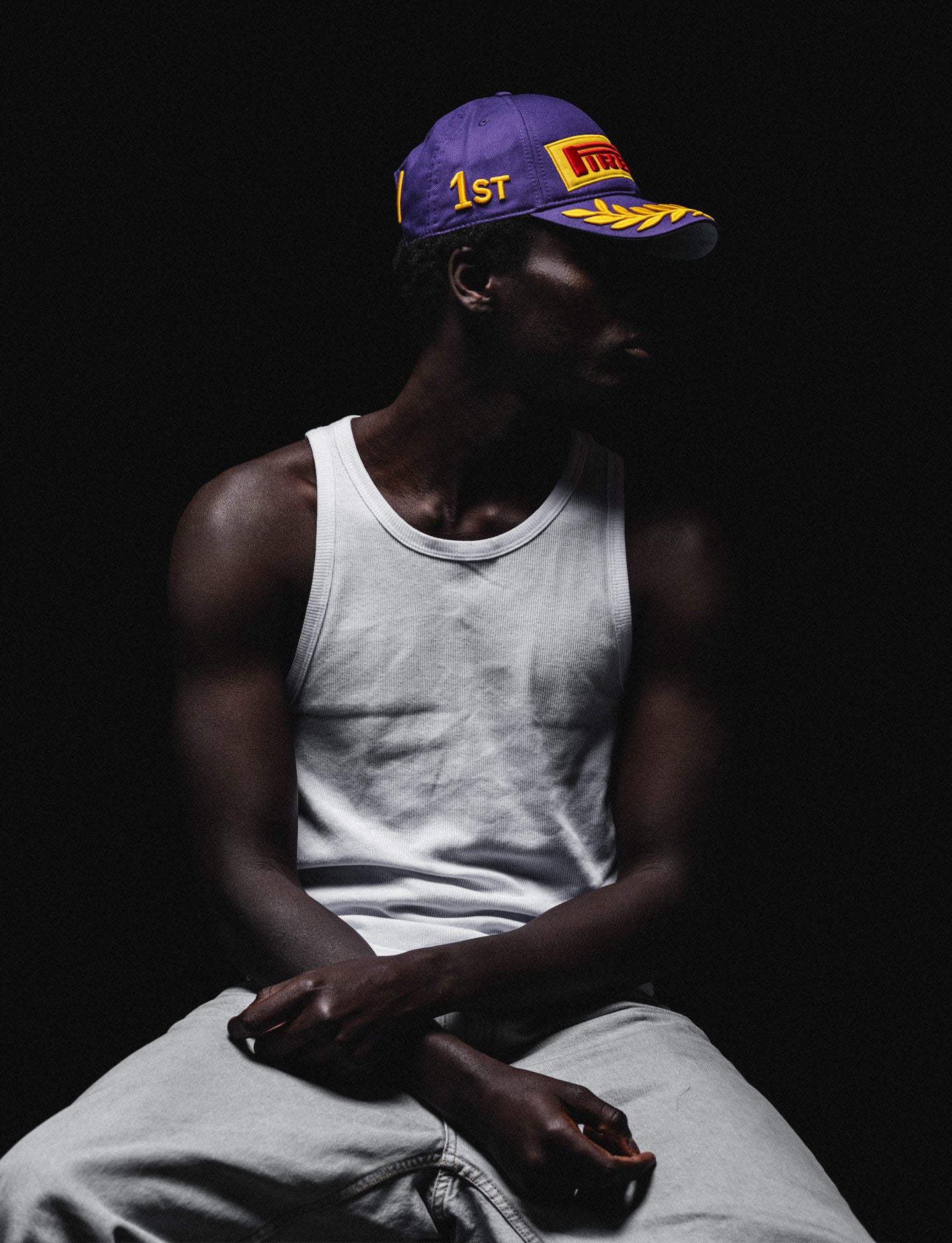 man in F1 Academy Pirelli Podium cap against a black background