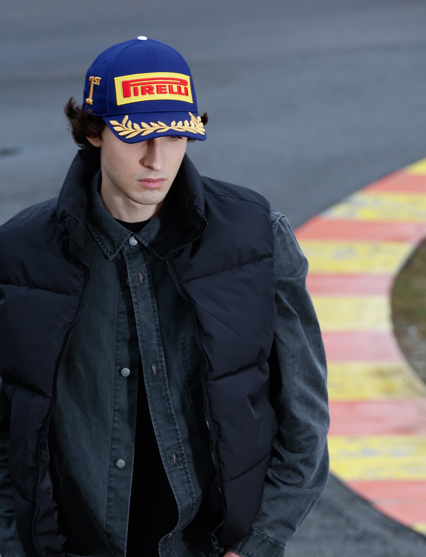 man with blue cap at racetrack