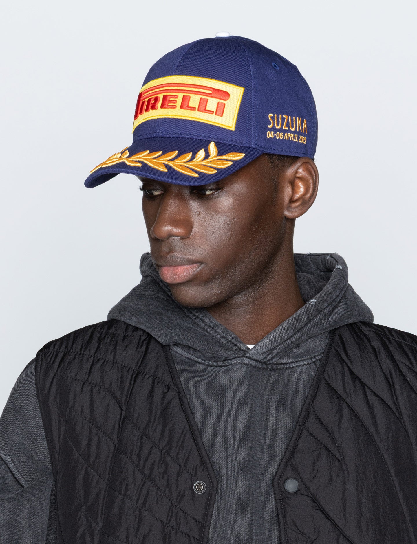 man with blue Pirelli cap side view