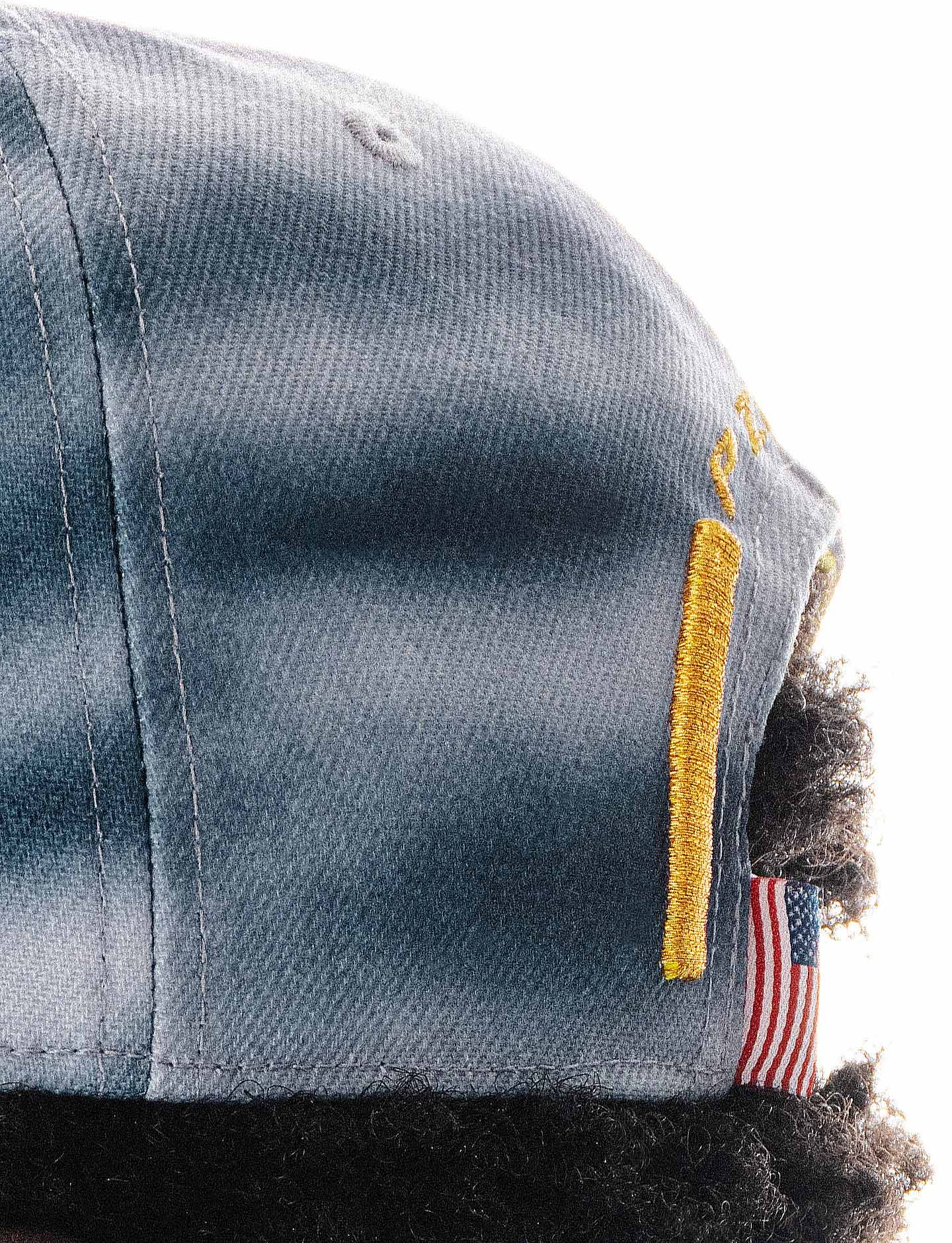 Close-up of a cap with an American flag patch on a white background