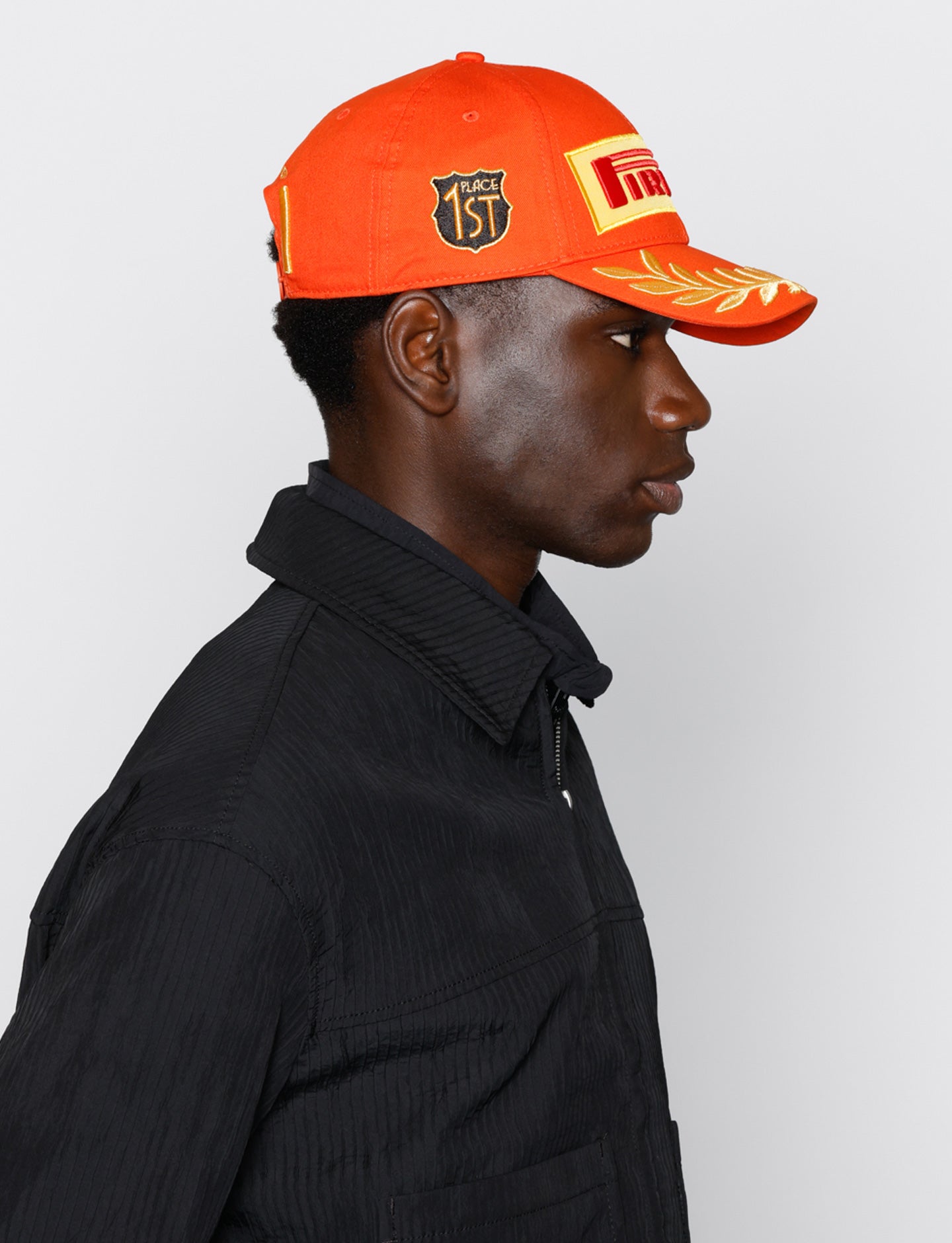 man in Orange Pirelli Podium Cap
