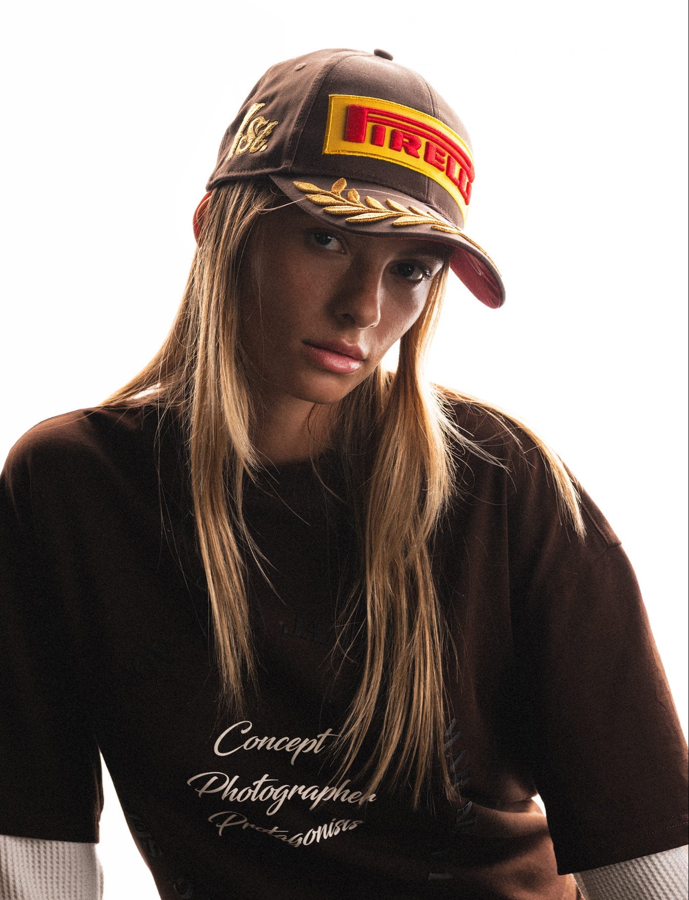 woman wearing brown Pirelli cap and tee