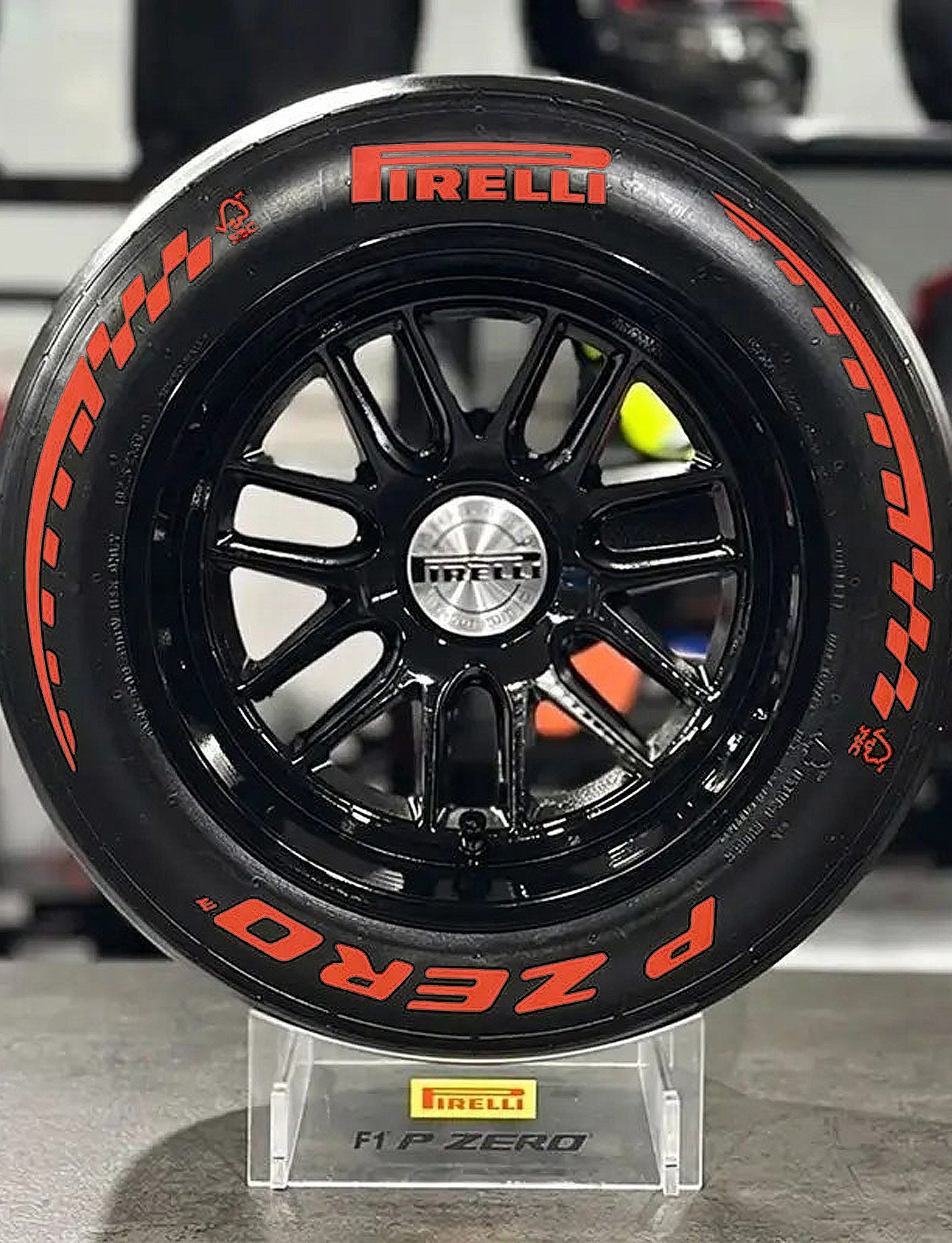 Pirelli tire on a black rim with red lettering on a gray surface