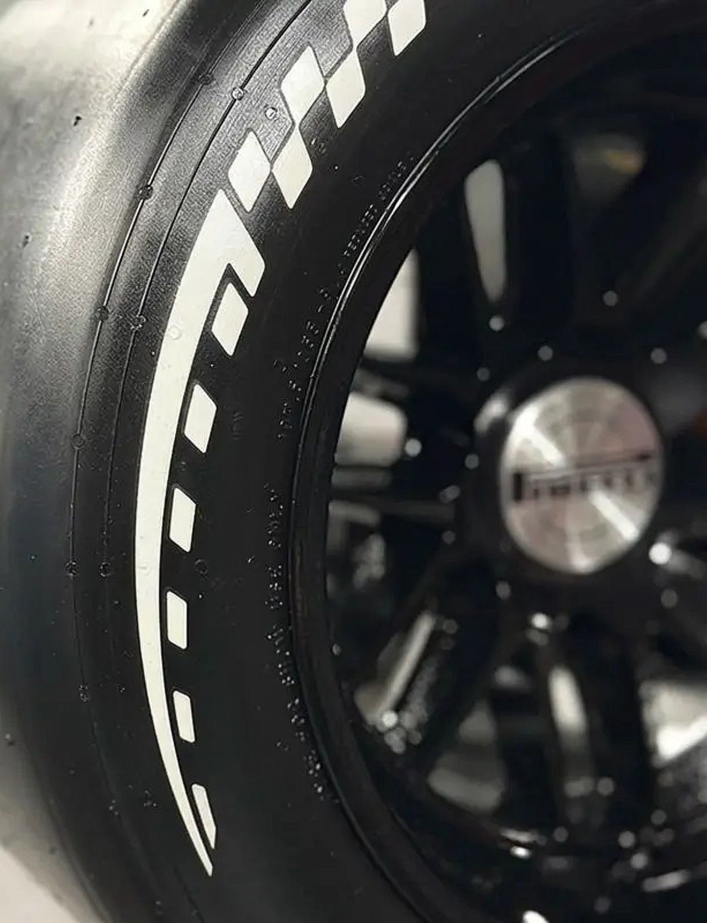 Close-up of a black car wheel with a visible Pirelli brand logo.