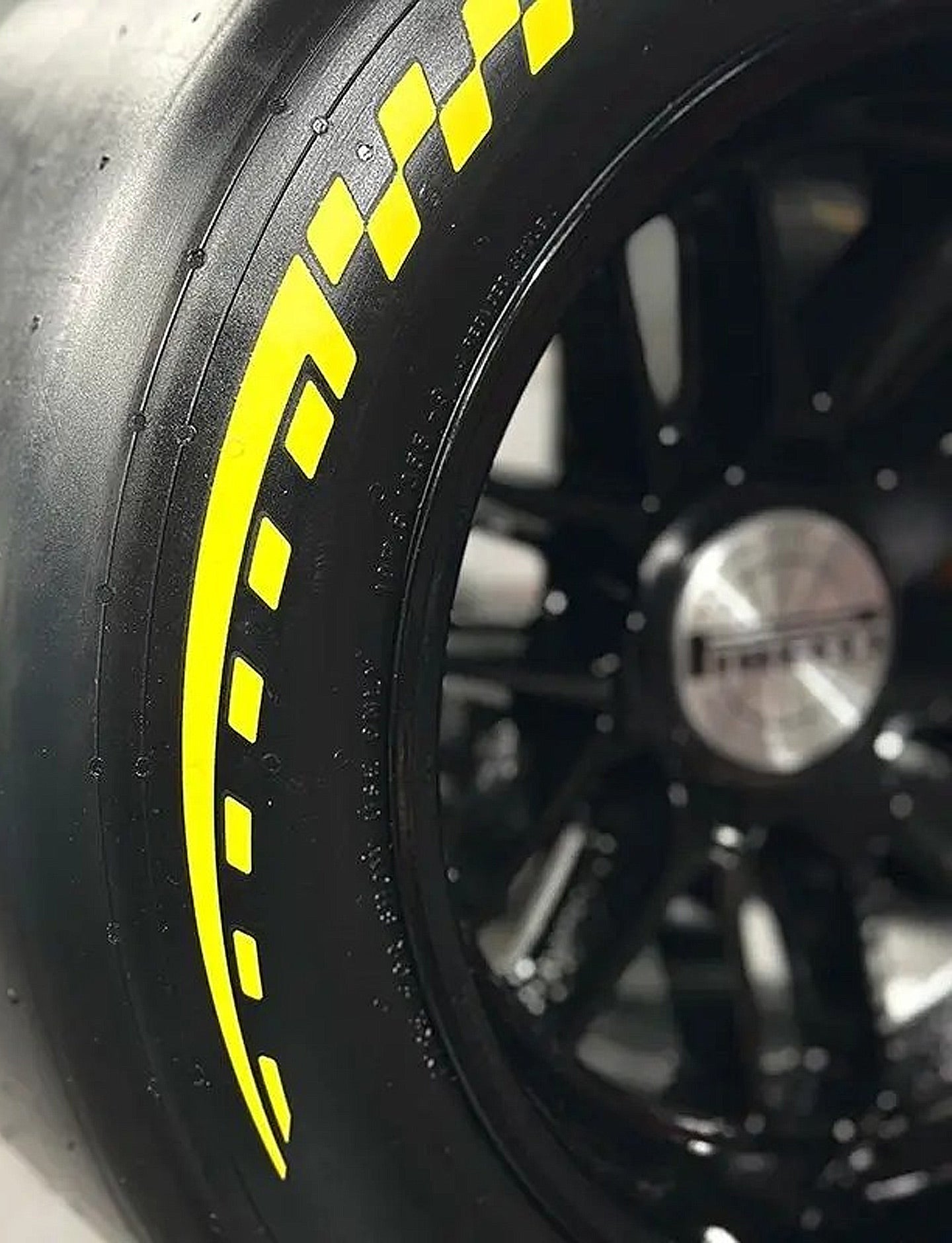 Close-up of a tire with yellow rim and black wheel rim